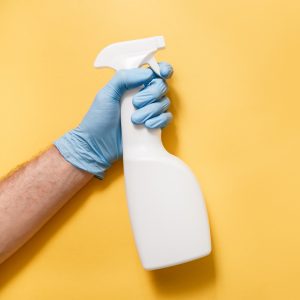 Cleaning Service Worker. Male hand with bottle of disinfectant